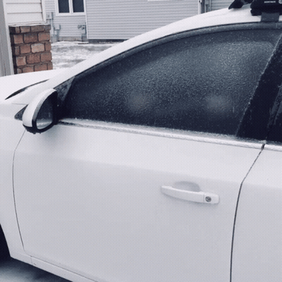 White Car Parked In Front Of House With Roof Rack GIF