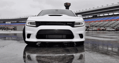 White Car Parked In Wet Parking Lot GIF