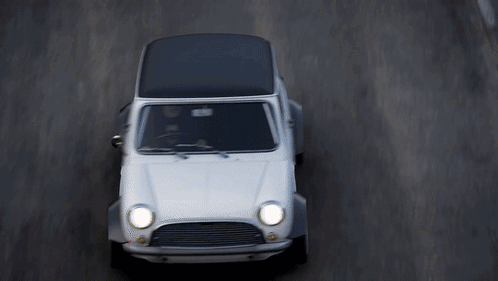 White Car With Black Top Driving Down Road GIF