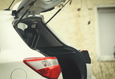 White Car With Open Trunk And Lit Tail Light GIF