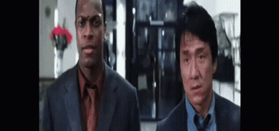 White Car With Red And Blue Lights Driving Down Street GIF