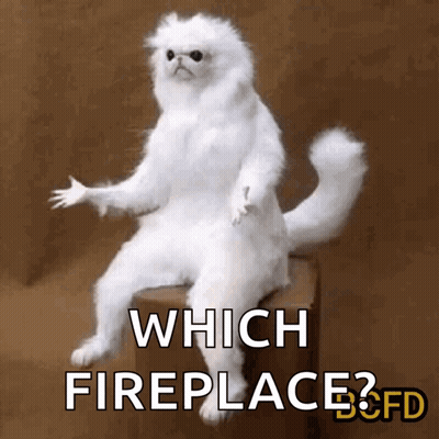 White Cat Sitting On Box Which Fireplace GIF