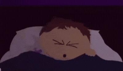 White Cat With Black Stripe Sitting On Couch GIF