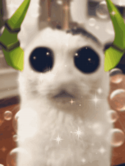 White Cat With Green Horns And Big Eyes GIF
