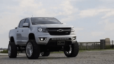 White Chevrolet Colorado Pickup Truck In Gravel Lot GIF