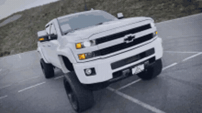 White Chevrolet Truck Driving Down Road