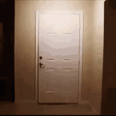White Door In Hallway Next To Wall GIF