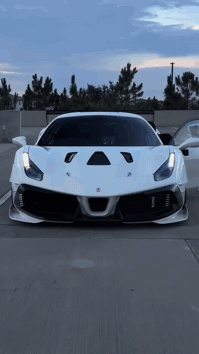 White Ferrari Parked In Lot GIF