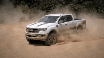 White Ford Truck Driving Through Sandy Area GIF