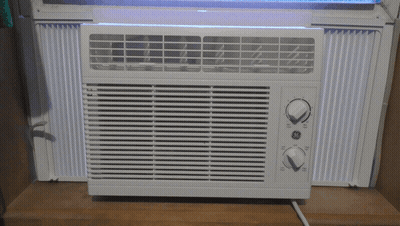 White GE Window Air Conditioner On Wooden Shelf GIF
