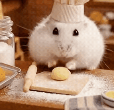 White Hamster In Chef Hat Beside Cutting Board GIF