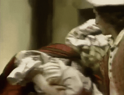 White Hat Man Near Red Dress Woman GIF