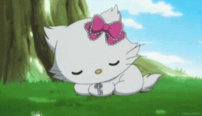 White Hello Kitty Sleeping In Grass With Pink Bow GIF