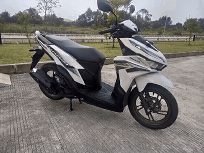 White Honda Scooter Parked On Concrete GIF