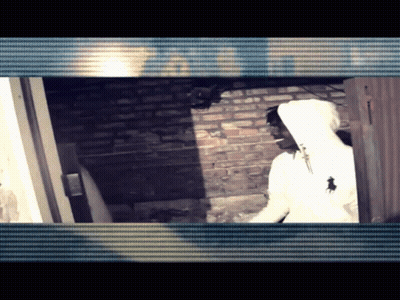 White Hoodie Man By Brick Wall And Door GIF