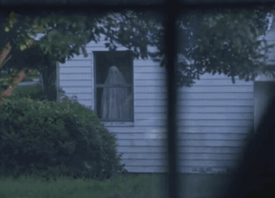 White House With Ghost Looking Out Window GIF