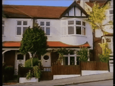 White House With Red Tile Roof And Wooden Fence GIF