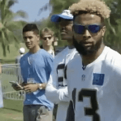 White Jersey 13 Sunglasses Man Next To Another GIF