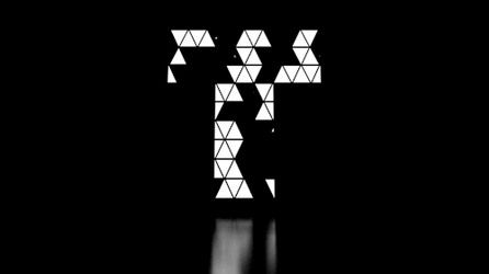 White Letter T Made Of Small Triangles GIF