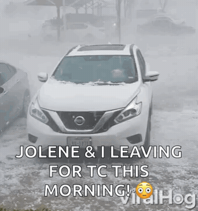 White Nissan SUV Driving Through Snowy Street GIF