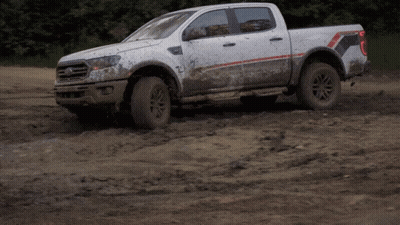 White Pickup Truck Driving Through Muddy Field GIF