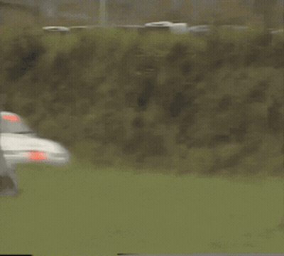 White Race Car With Red Stripe Driving GIF