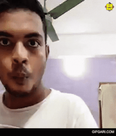 White Shirt Man Looking At Camera, Ceiling Fan GIF