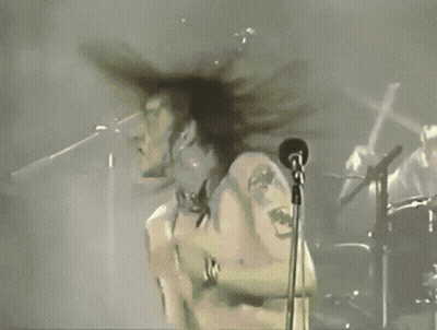 White Shirt Man Singing Into Microphone Arms Outstretched GIF