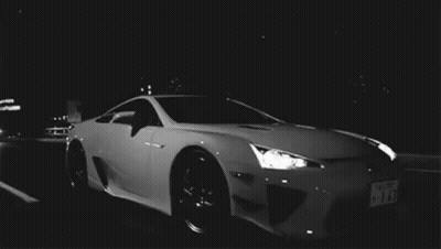 White Sports Car Parked In Dark Parking Lot At Night GIF