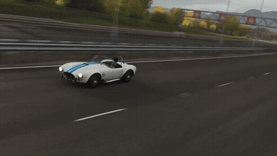 White Sports Car With Blue Strip On Highway GIF