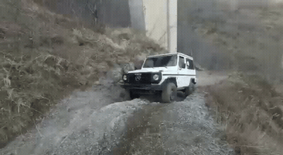 White SUV Driving Down Dirt Road GIF