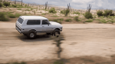 White SUV Driving On Dirt Road GIF