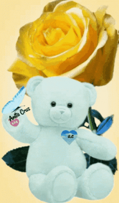 White Teddy Bear With Blue Heart Beside Yellow Rose GIF