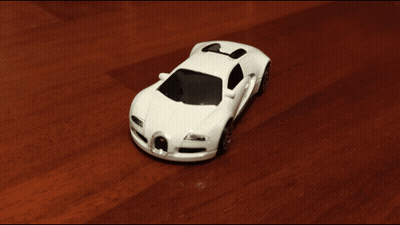 White Toy Car On Wooden Surface GIF