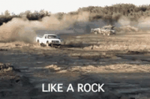 White Truck Driving Down Dirt Road Like A Rock GIF