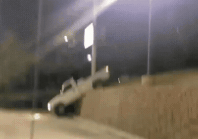 White Truck Driving Down Road At Night GIF