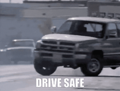 White Truck Driving Down Street Saying Drive Safe GIF