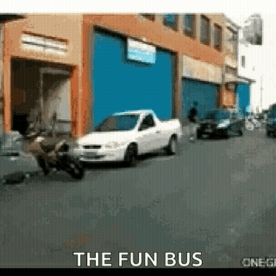 White Truck Parked In Front Of The Fun Bus GIF
