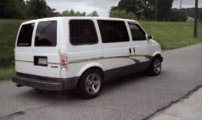 White Van Driving Down Road With Trees GIF