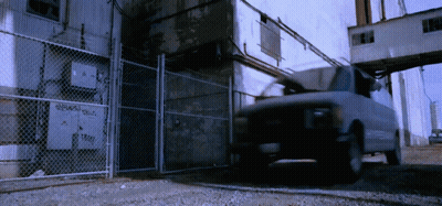 White Van Parked In Front Of Chain Link Fence GIF