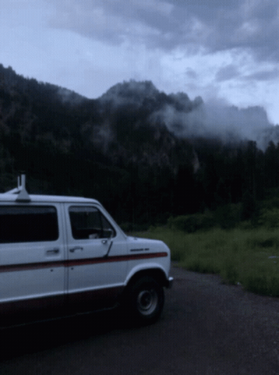 White Van Parked In Front Of Mountain GIF