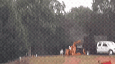 White Van Parked Next To Tractor GIF