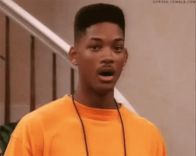 Will Smith Is Wearing An Orange T-Shirt And A Necklace And Making A Surprised Face . GIF