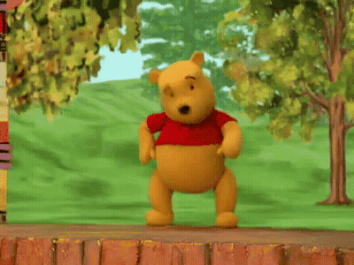Winnie The Pooh Doll Laying On Brick Wall GIF