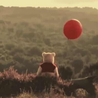 Winnie The Pooh Is Looking At A Red Balloon In The Sky GIF