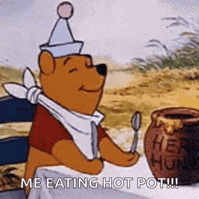 Winnie The Pooh Is Sitting At A Table Holding A Spoon And A Jar Of Honey . GIF