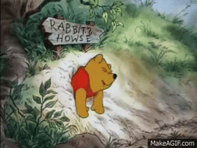 Winnie The Pooh Is Standing Next To A Wooden Sign That Says Rabbit 'S House . GIF