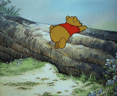 Winnie The Pooh Laying On Tree Trunk GIF