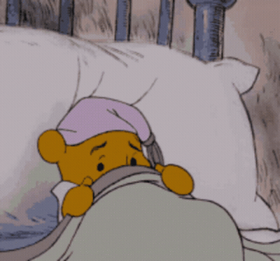 Winnie The Pooh Lying In Bed With Purple Hat GIF