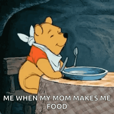 Winnie The Pooh Sitting At A Table With A Bowl Of Food GIF